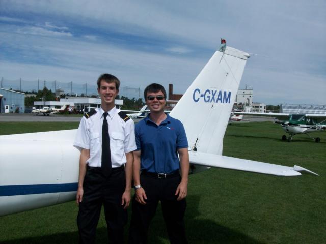 Alexey Dudkin and Instructor Jeff Davey: After the flight Instructor and student pilot pose in front of Cessna 150 trainer..